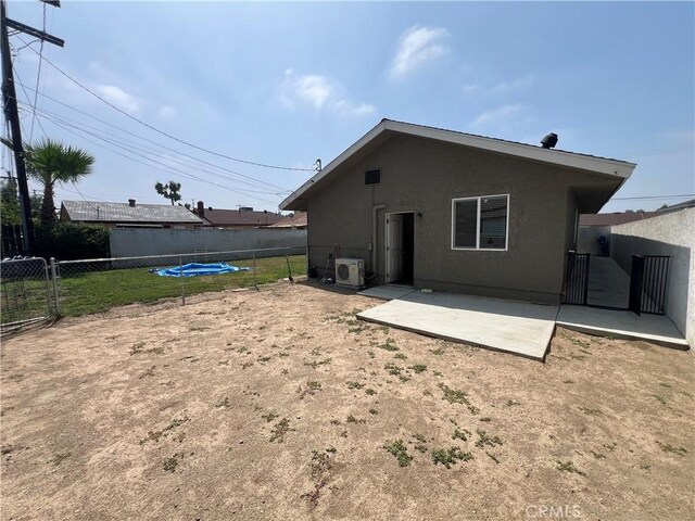 246 E 27th St, San Bernardino, CA 92404 - rear view of property featuring a patio, stucco siding, and a fenced backyard