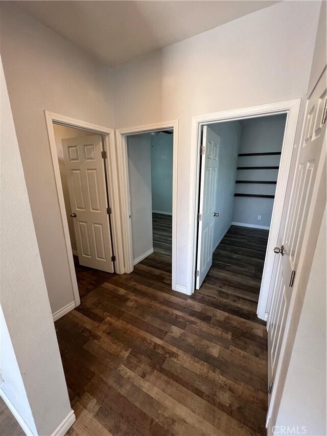 246 E 27th St, San Bernardino, CA 92404 - hallway featuring dark wood-type flooring and baseboards