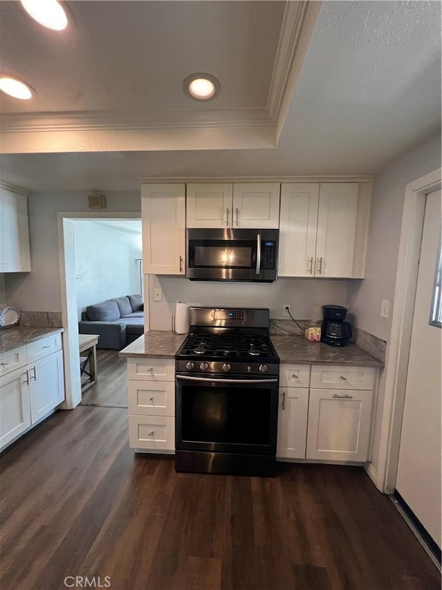 246 E 27th St, San Bernardino, CA 92404 - kitchen featuring stainless steel microwave, black gas stove, crown molding, white cabinetry, and a tray ceiling