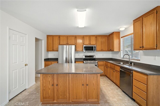 39312 Via Belleza, Murrieta, CA 92563 - kitchen featuring stainless steel appliances, a center island, and brown cabinets