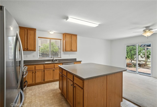 39312 Via Belleza, Murrieta, CA 92563 - kitchen with appliances with stainless steel finishes, dark countertops, plenty of natural light, and brown cabinets