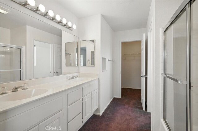 39312 Via Belleza, Murrieta, CA 92563 - bathroom with a shower with shower door, double vanity, and a walk in closet