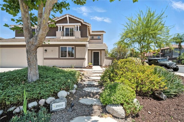 39312 Via Belleza, Murrieta, CA 92563 - view of front facade with stucco siding, a garage, and a tile roof