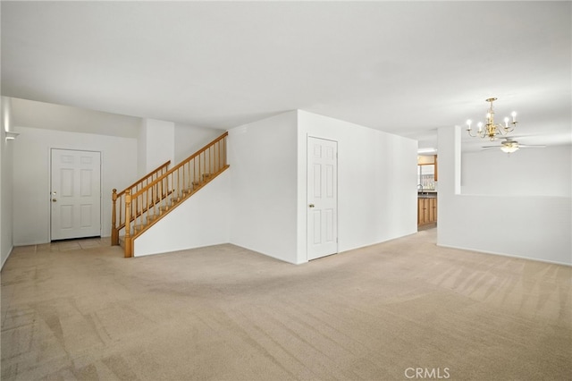 39312 Via Belleza, Murrieta, CA 92563 - unfurnished living room with carpet floors, a chandelier, and stairs