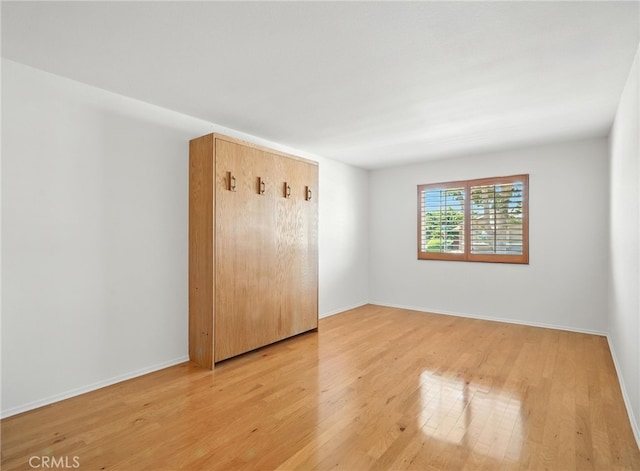 39312 Via Belleza, Murrieta, CA 92563 - unfurnished bedroom with light wood-style flooring and baseboards