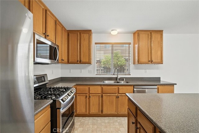 39312 Via Belleza, Murrieta, CA 92563 - kitchen with appliances with stainless steel finishes, brown cabinetry, and dark countertops