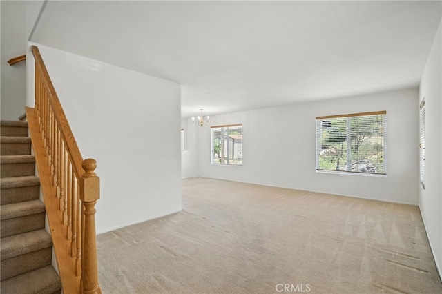 39312 Via Belleza, Murrieta, CA 92563 - spare room featuring light carpet, a chandelier, and stairway