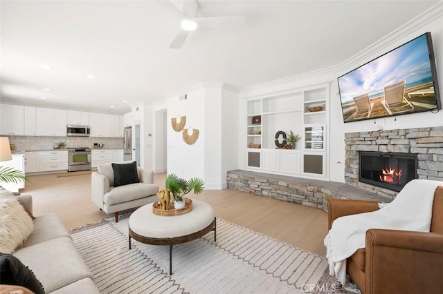 6407 Ruby, Carlsbad, CA 92011 - living room featuring light wood-type flooring, a fireplace, built in shelves, ceiling fan, and ornamental molding