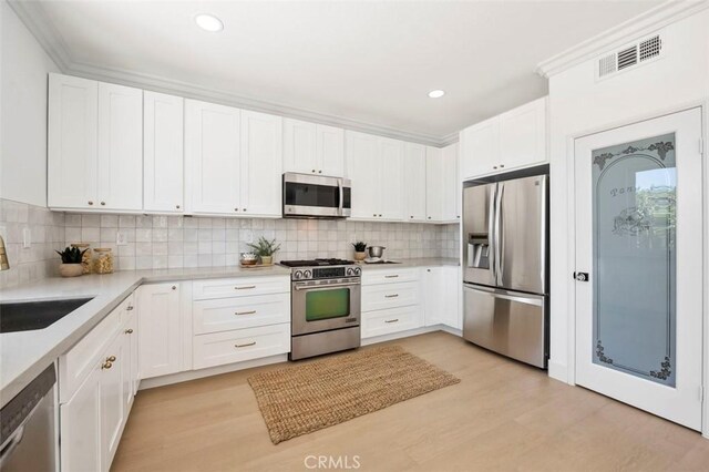 6407 Ruby, Carlsbad, CA 92011 - kitchen featuring stainless steel appliances, light countertops, tasteful backsplash, white cabinetry, and recessed lighting