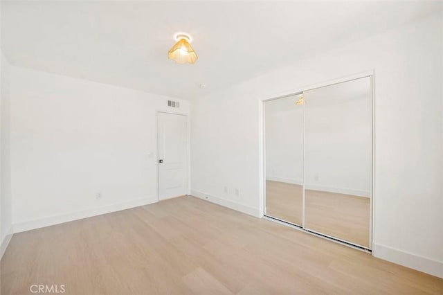 6407 Ruby, Carlsbad, CA 92011 - unfurnished bedroom with wood finished floors and a closet