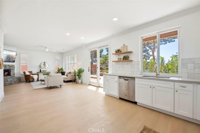 6407 Ruby, Carlsbad, CA 92011 - kitchen with stainless steel dishwasher, crown molding, plenty of natural light, light countertops, and backsplash