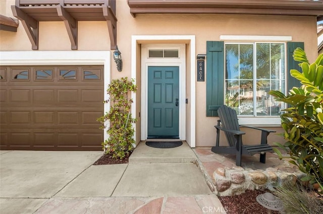 6407 Ruby, Carlsbad, CA 92011 - doorway to property featuring stucco siding, a garage, and driveway