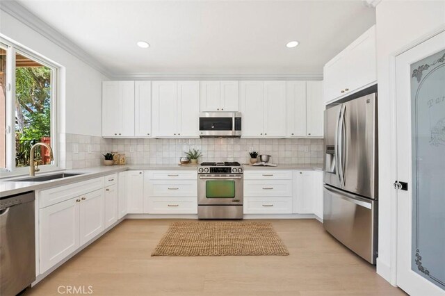 6407 Ruby, Carlsbad, CA 92011 - kitchen featuring stainless steel appliances, light countertops, white cabinetry, recessed lighting, and ornamental molding