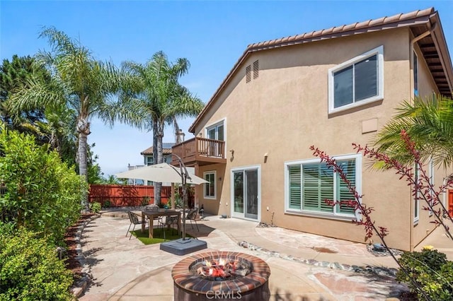 6407 Ruby, Carlsbad, CA 92011 - back of house featuring a balcony, a patio area, stucco siding, a fire pit, and outdoor dining space