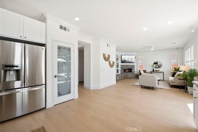 6407 Ruby, Carlsbad, CA 92011 - kitchen featuring stainless steel refrigerator with ice dispenser, light wood finished floors, white cabinetry, ornamental molding, and a fireplace