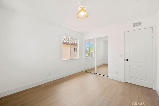 6407 Ruby, Carlsbad, CA 92011 - unfurnished bedroom with light wood-style flooring and a closet