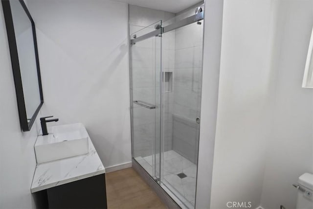 10324 Silverton Ave, Tujunga, CA 91042 - bathroom with a stall shower, wood finished floors, and double vanity