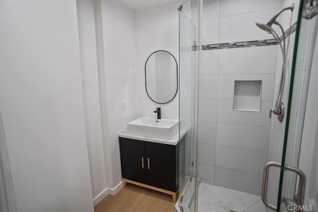 10324 Silverton Ave, Tujunga, CA 91042 - full bath with a stall shower, vanity, and wood finished floors