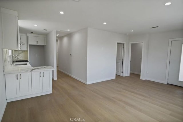10324 Silverton Ave, Tujunga, CA 91042 - kitchen featuring recessed lighting, light wood-style flooring, and white cabinetry