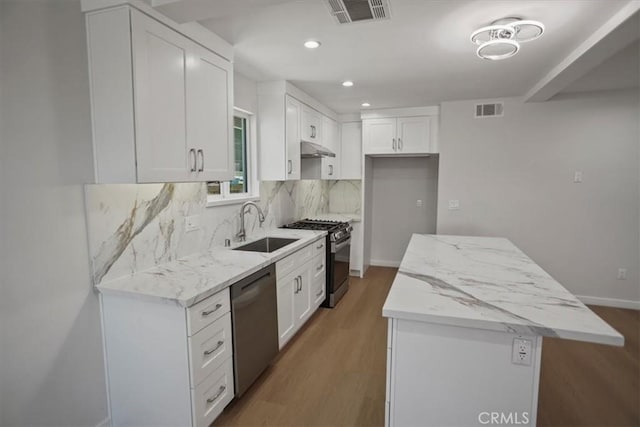 10324 Silverton Ave, Tujunga, CA 91042 - kitchen with appliances with stainless steel finishes, backsplash, wood finished floors, light stone countertops, and recessed lighting