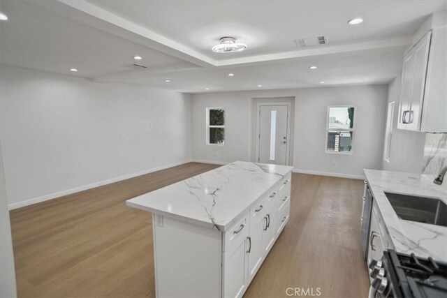 10324 Silverton Ave, Tujunga, CA 91042 - kitchen featuring open floor plan, light wood-type flooring, white cabinets, gas range, and recessed lighting