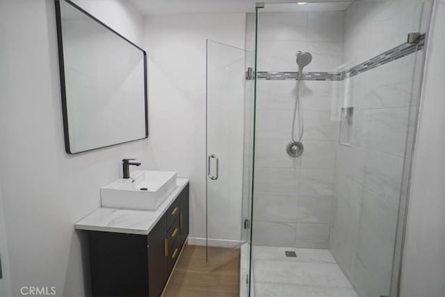 10324 Silverton Ave, Tujunga, CA 91042 - bathroom featuring vanity, a stall shower, and wood finished floors