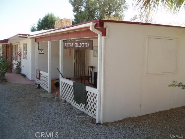 67190 Dillon Rd, Desert Hot Springs, CA 92240 - view of home's exterior featuring a chimney and stucco siding
