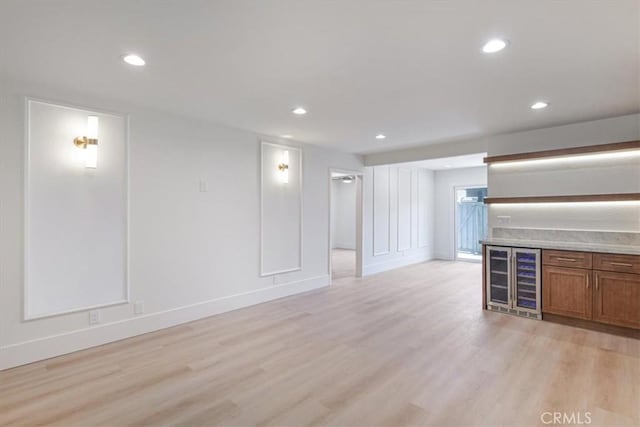 229 Springview, Irvine, CA 92620 - unfurnished living room with beverage cooler, light wood finished floors, recessed lighting, and a bar