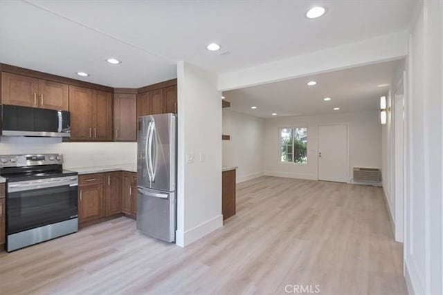 229 Springview, Irvine, CA 92620 - kitchen with stainless steel appliances, light wood-type flooring, recessed lighting, light countertops, and open floor plan