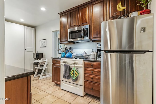 357 Northcliff Rd, Pasadena, CA 91107 - kitchen with stainless steel appliances, dark countertops, light tile patterned floors, recessed lighting, and dark brown cabinets