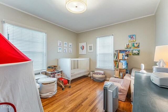 357 Northcliff Rd, Pasadena, CA 91107 - bedroom with wood finished floors, crown molding, and a nursery area