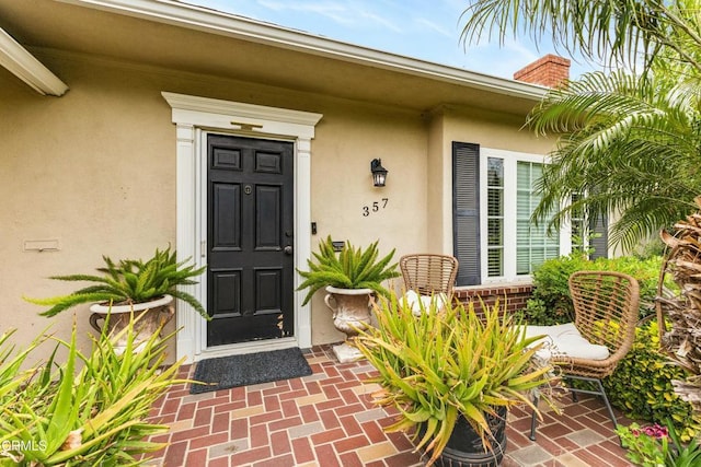 357 Northcliff Rd, Pasadena, CA 91107 - doorway to property with stucco siding and a chimney