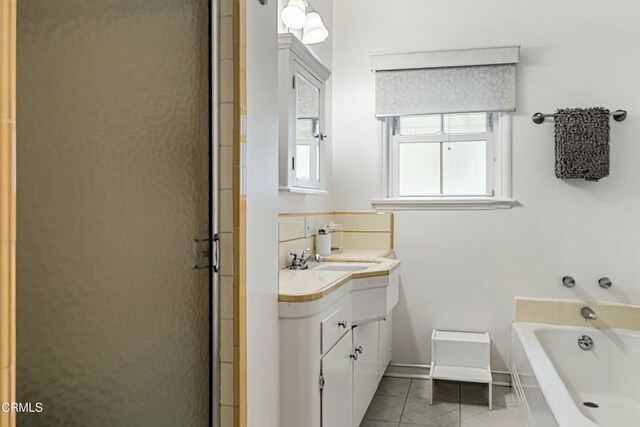 357 Northcliff Rd, Pasadena, CA 91107 - bathroom featuring marble finish floors, vanity, a garden tub, and a stall shower