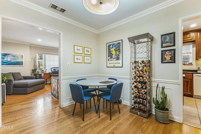 357 Northcliff Rd, Pasadena, CA 91107 - dining room featuring ornamental molding, light wood-style flooring, a decorative wall, and wainscoting
