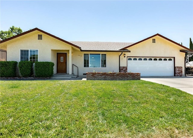 1019 W Monterey St, Orland, CA 95963 - ranch-style home featuring stucco siding, an attached garage, driveway, and a front yard