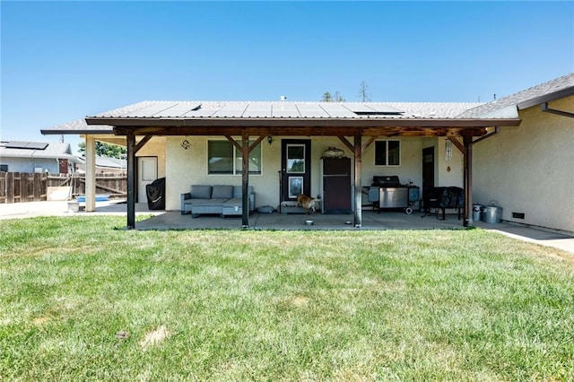 1019 W Monterey St, Orland, CA 95963 - back of house with stucco siding, a patio, roof mounted solar panels, and an outdoor hangout area