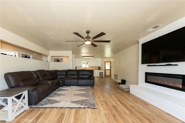 1019 W Monterey St, Orland, CA 95963 - living area featuring a ceiling fan, light wood finished floors, and a glass covered fireplace