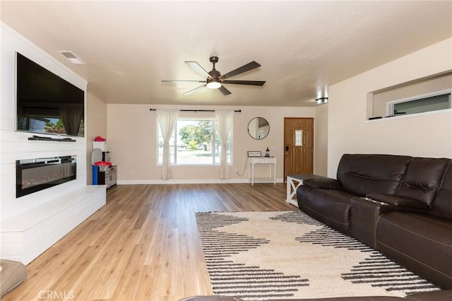 1019 W Monterey St, Orland, CA 95963 - living area with wood finished floors, ceiling fan, and a glass covered fireplace