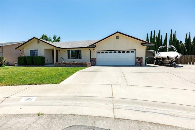 1019 W Monterey St, Orland, CA 95963 - ranch-style house featuring a garage, stucco siding, driveway, and a front yard