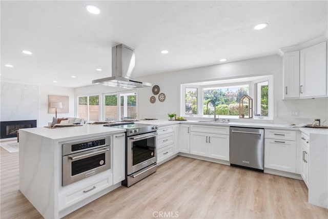 26982 Pueblonuevo Dr, Mission Viejo, CA 92691 - kitchen with stainless steel appliances, island exhaust hood, a peninsula, recessed lighting, and white cabinetry