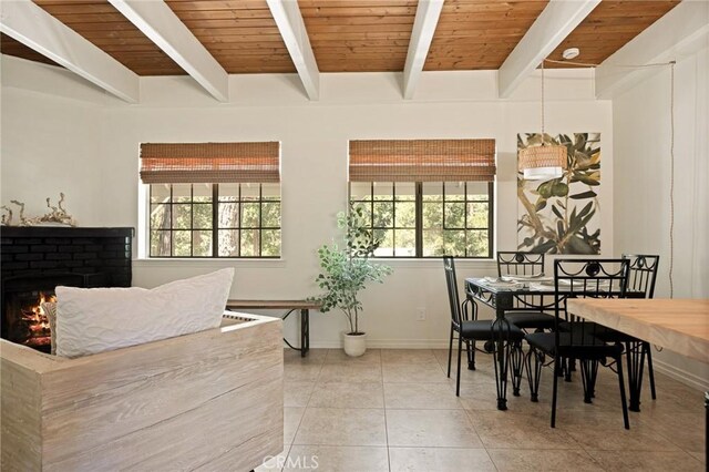 531 Rose Ln, Twin Peaks, CA 92391 - dining space with beamed ceiling, tile patterned flooring, and a fireplace