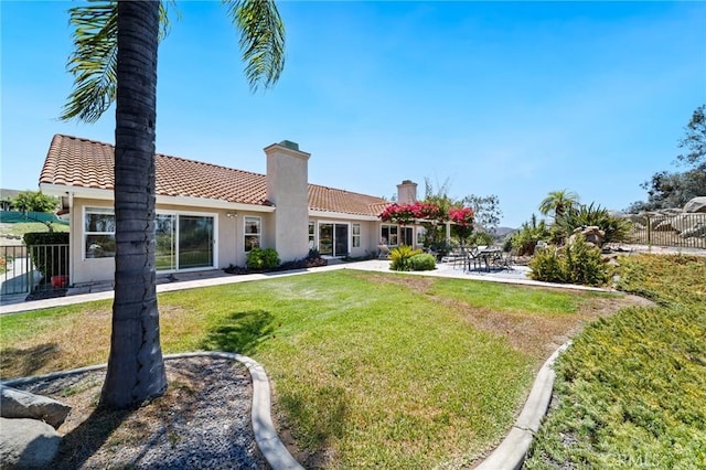 11056 Orchard View Ln, Riverside, CA 92503 - rear view of house with a chimney, a tiled roof, stucco siding, and a patio
