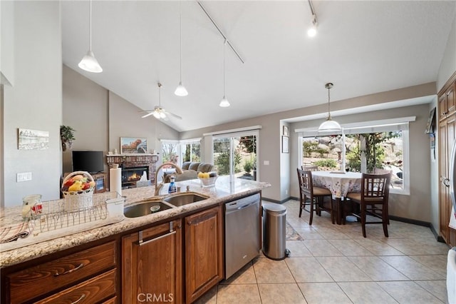 11056 Orchard View Ln, Riverside, CA 92503 - kitchen featuring dishwasher, a fireplace, brown cabinets, a ceiling fan, and light stone countertops