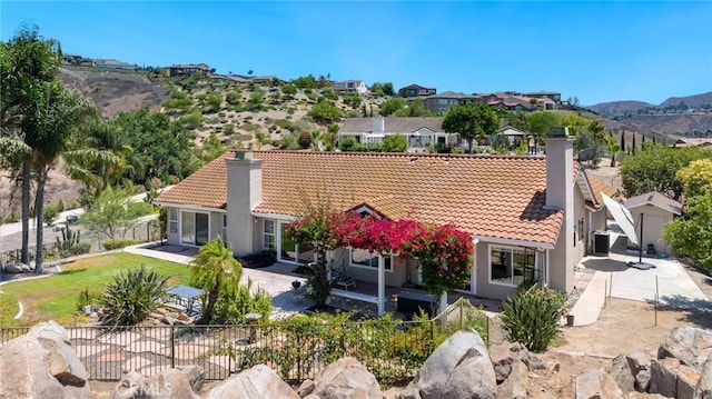 11056 Orchard View Ln, Riverside, CA 92503 - back of house with a chimney, a tiled roof, stucco siding, and a mountain view