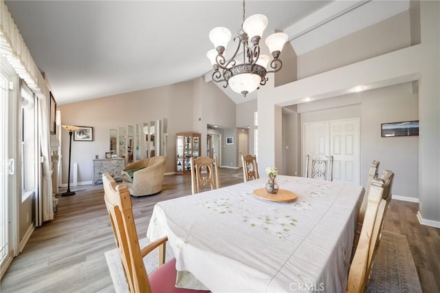 11056 Orchard View Ln, Riverside, CA 92503 - dining room featuring light wood-style flooring, a chandelier, and high vaulted ceiling