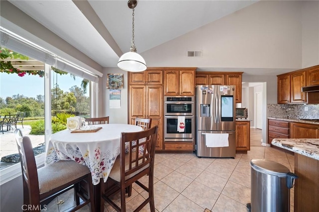 11056 Orchard View Ln, Riverside, CA 92503 - kitchen with appliances with stainless steel finishes, tasteful backsplash, brown cabinetry, light tile patterned flooring, and high vaulted ceiling