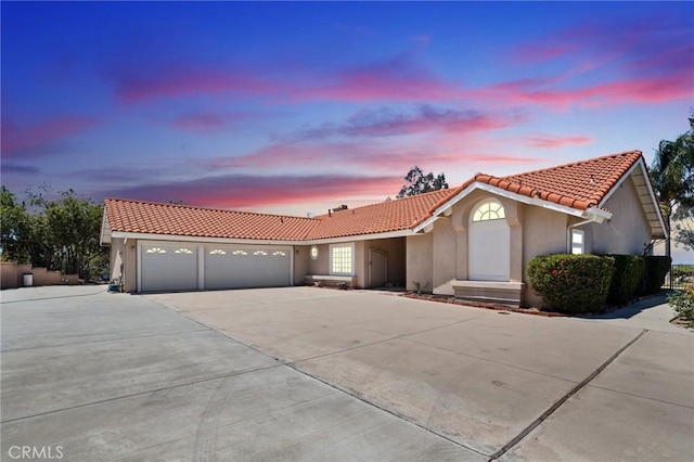 11056 Orchard View Ln, Riverside, CA 92503 - view of front facade featuring a tile roof, stucco siding, an attached garage, and concrete driveway