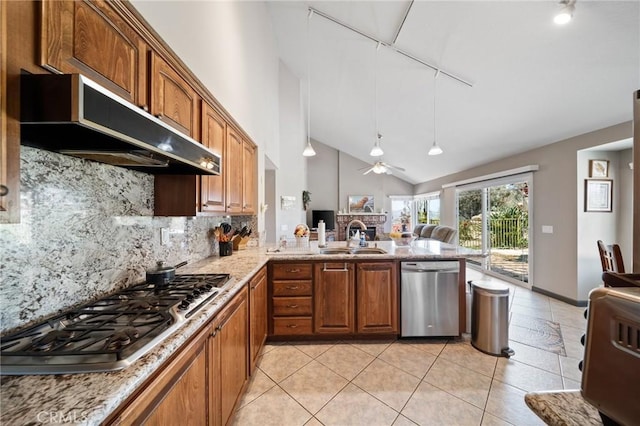 11056 Orchard View Ln, Riverside, CA 92503 - kitchen with appliances with stainless steel finishes, under cabinet range hood, decorative backsplash, brown cabinetry, and a ceiling fan