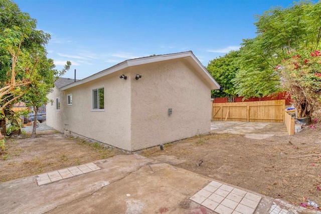 254 Rexview Dr, San Diego, CA 92114 - view of side of property with stucco siding and a patio area