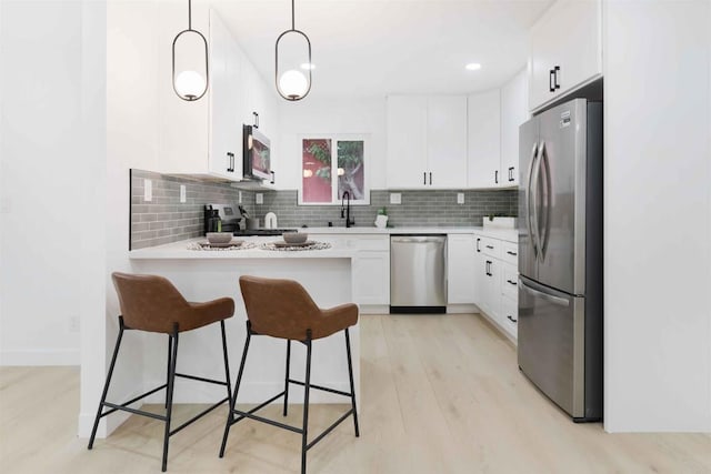 254 Rexview Dr, San Diego, CA 92114 - kitchen with appliances with stainless steel finishes, a peninsula, light countertops, and decorative backsplash